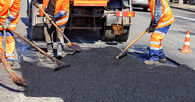 Construction crew re-paving road