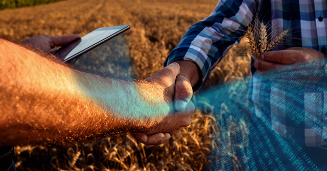 Farmers shaking hands with ipad