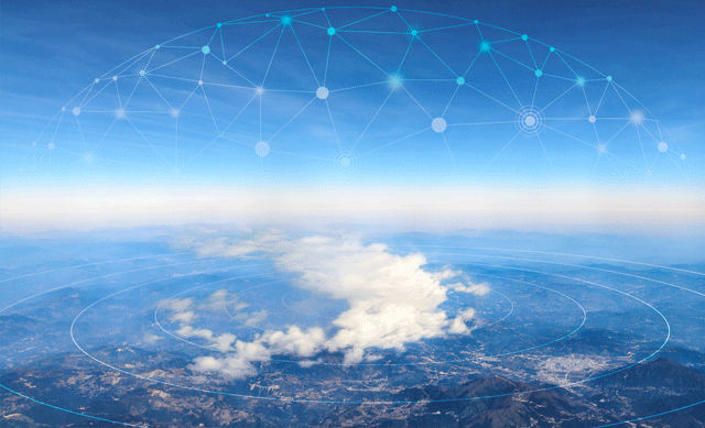 birds eye view of earth through hazy clouds with digital dot and wave overlay