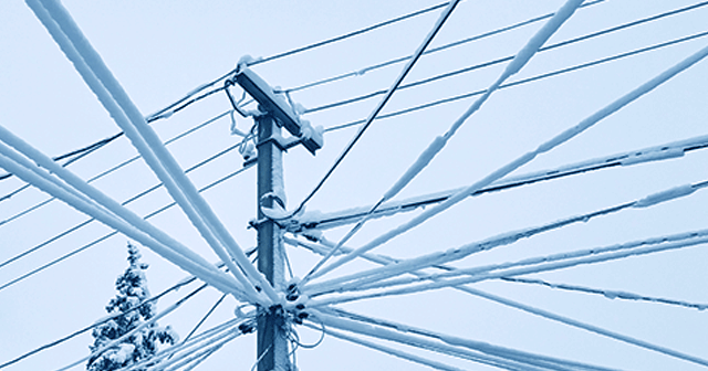 Blue tinted snow covered powerlines