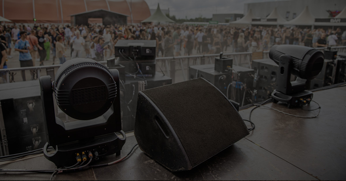looking out on crowd over speaker and lights on stage