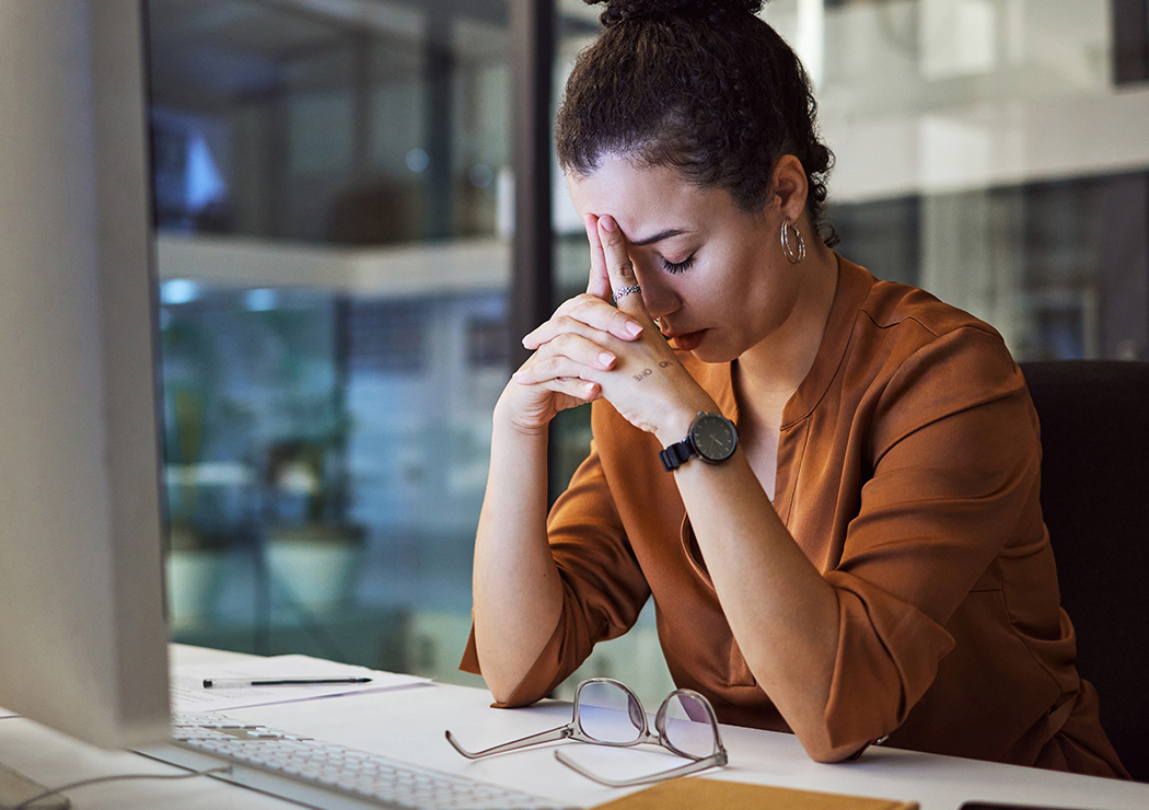 business woman at night at computer with stress and anxiety