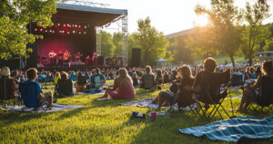 Concertgoers Relaxing in Grassy Area Facing Stage